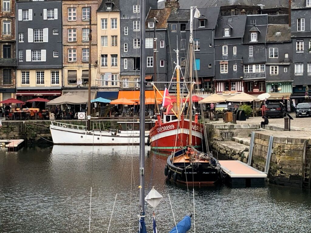 photo reference for paint-along of boats in the harbor with buildings behind in Honfleur, France