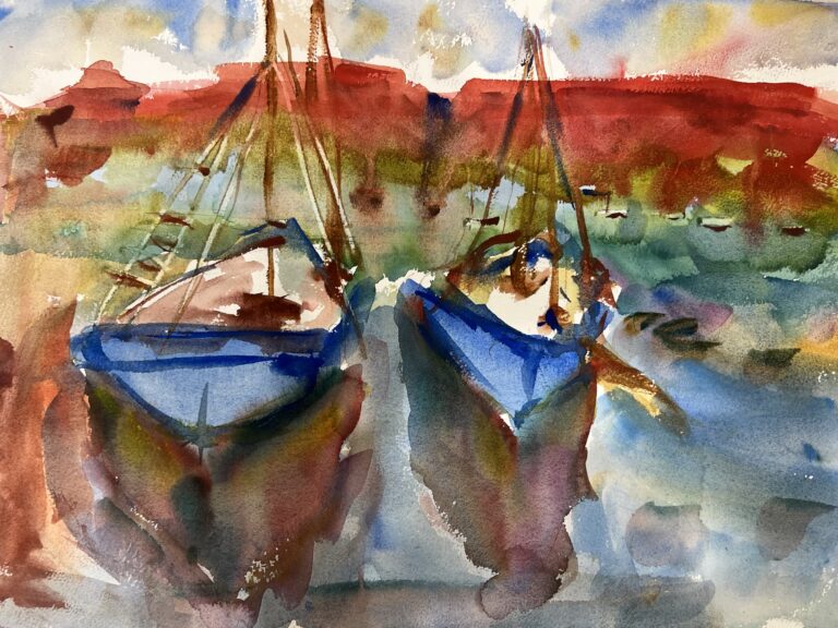 Idyll Harbor, original watercolor painting of two blue sailboats in water. There is a bank of red and green behind them and purplish reflections from the boats on the water.